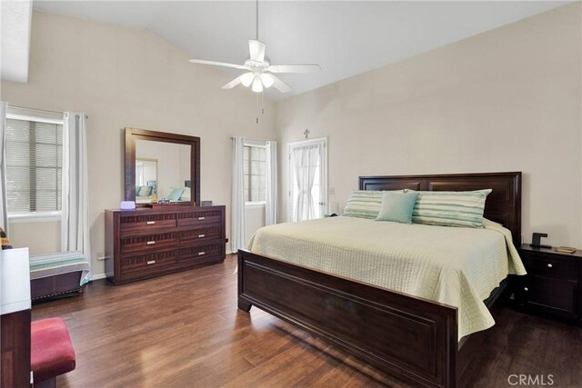 bedroom with lofted ceiling, multiple windows, wood finished floors, and a ceiling fan