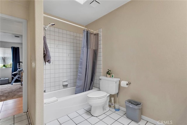 bathroom featuring shower / bath combination with curtain, visible vents, toilet, baseboards, and tile patterned floors