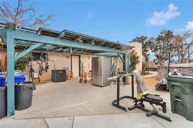 view of patio with cooling unit and a pergola