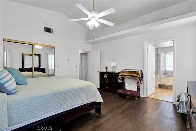 bedroom with wood finished floors, visible vents, vaulted ceiling, multiple windows, and a closet