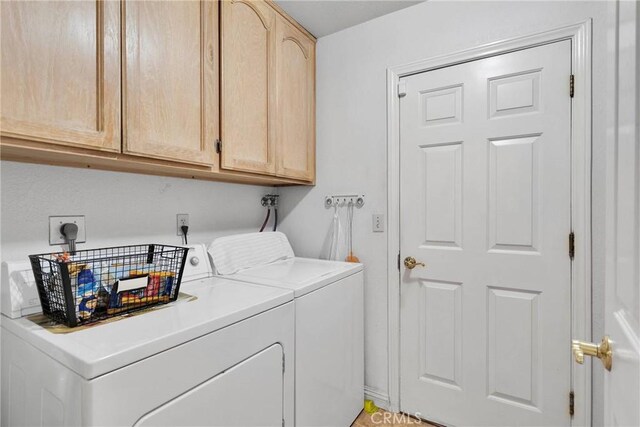 clothes washing area with cabinet space and washer and dryer