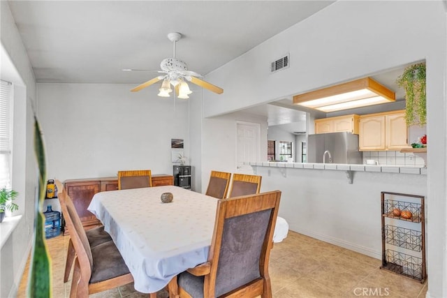 dining room with ceiling fan and visible vents