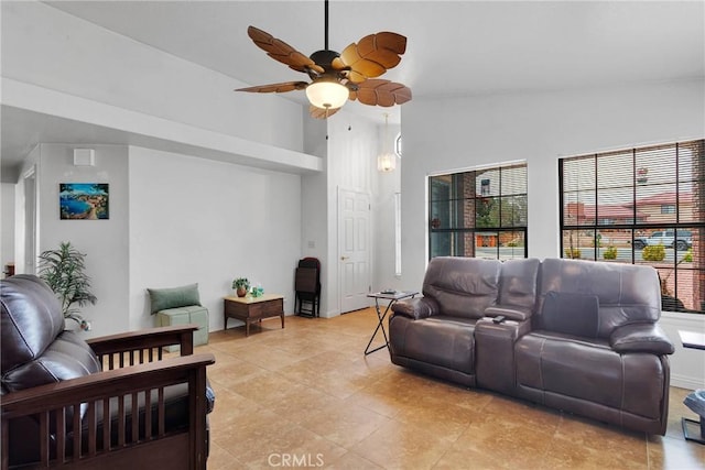 living area with ceiling fan and lofted ceiling