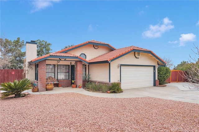 mediterranean / spanish-style house with a tile roof, a chimney, fence, a garage, and driveway