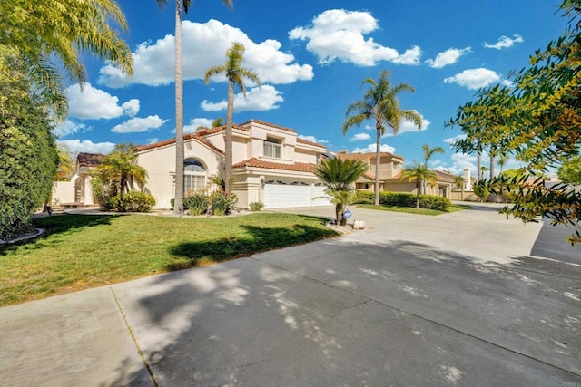 view of front of house with concrete driveway, a tile roof, a front lawn, and stucco siding