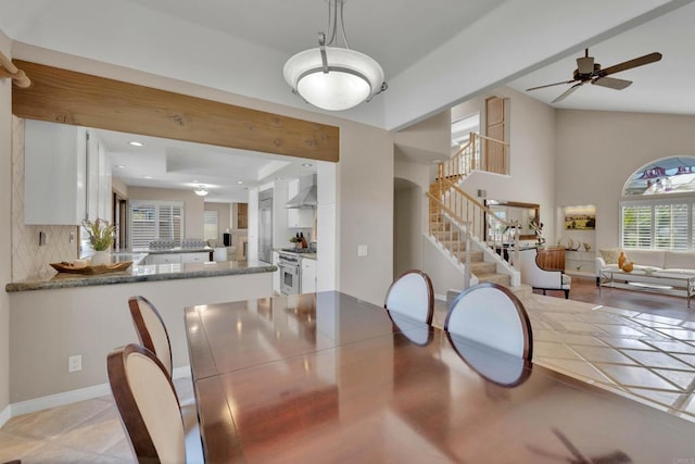 dining area with baseboards, lofted ceiling, ceiling fan, stairs, and recessed lighting