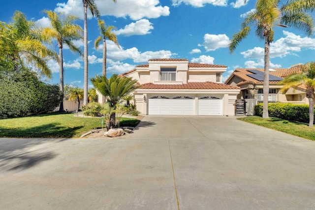 mediterranean / spanish home with a garage, driveway, fence, a front yard, and stucco siding