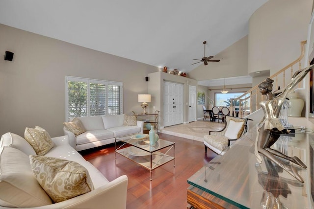 living room with a healthy amount of sunlight, a ceiling fan, high vaulted ceiling, and wood finished floors