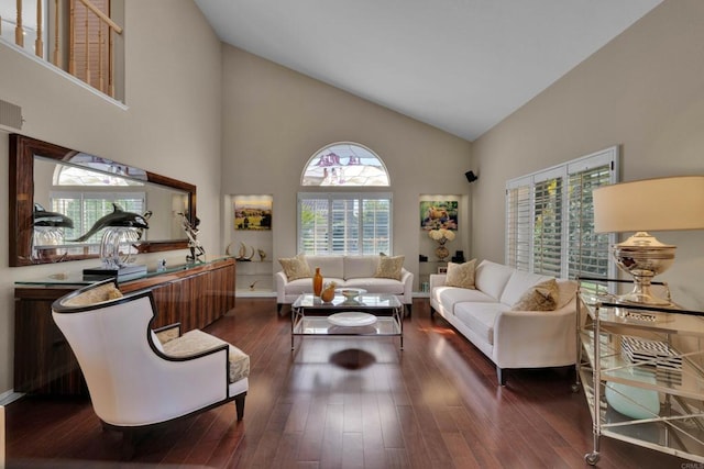 living area with baseboards, high vaulted ceiling, and dark wood finished floors