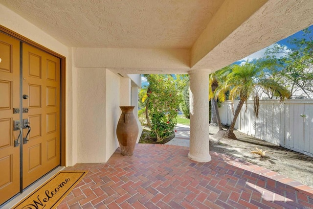 exterior space featuring fence and stucco siding