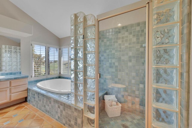 bathroom featuring tile patterned flooring, tiled shower, a garden tub, and lofted ceiling