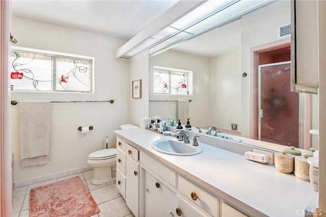 bathroom with visible vents, toilet, a stall shower, vanity, and tile patterned floors