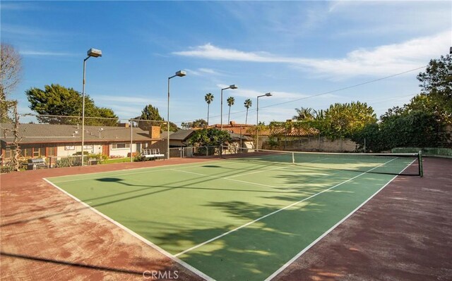 view of sport court featuring fence