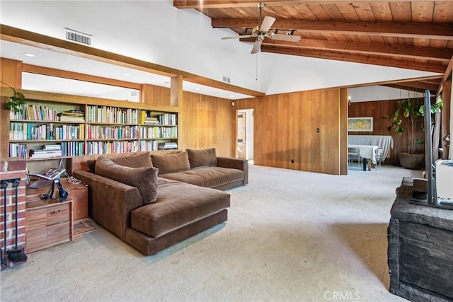 living area with carpet, vaulted ceiling with beams, visible vents, wooden walls, and wooden ceiling