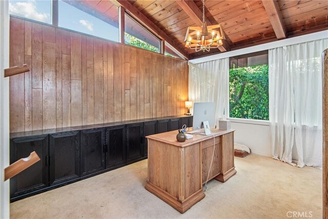 office area with a notable chandelier, lofted ceiling with beams, light carpet, wood walls, and wooden ceiling