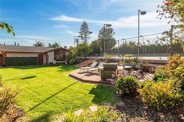 view of yard featuring fence and a patio