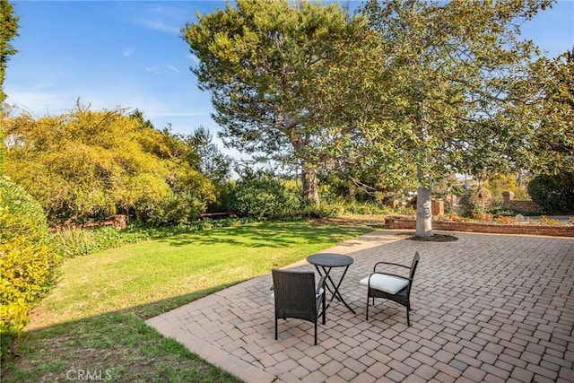 surrounding community featuring a lawn and a patio area