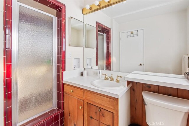 full bath with toilet, a shower stall, and vanity