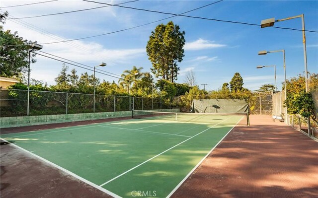 view of tennis court with fence