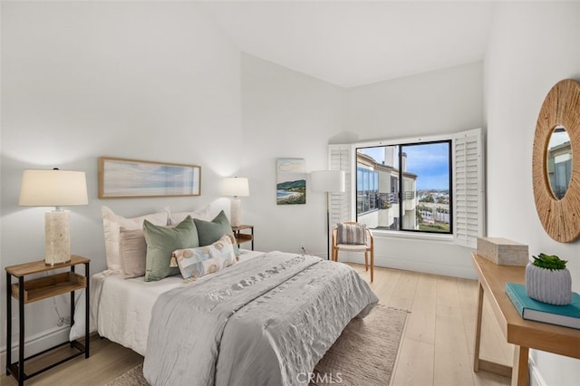 bedroom with light wood-style flooring and baseboards