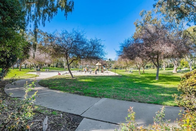 surrounding community featuring a lawn and playground community