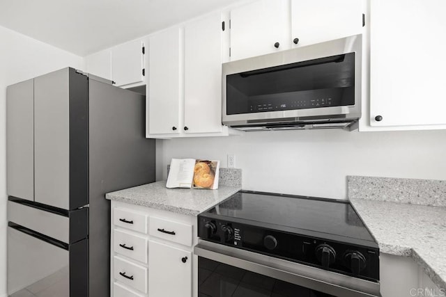 kitchen with stainless steel appliances and white cabinetry