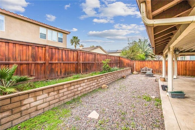 view of yard featuring a patio area and a fenced backyard