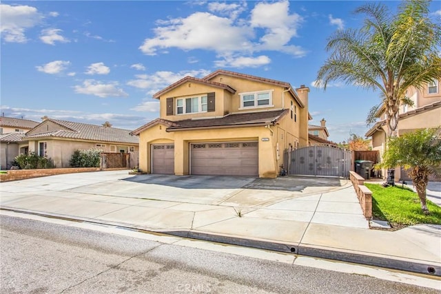 view of front facade featuring stucco siding, an attached garage, a gate, fence, and driveway