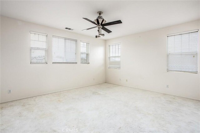 spare room with visible vents and ceiling fan