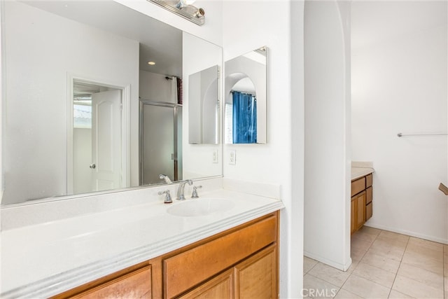 bathroom featuring a stall shower, tile patterned flooring, and vanity