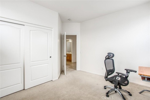 carpeted home office featuring baseboards