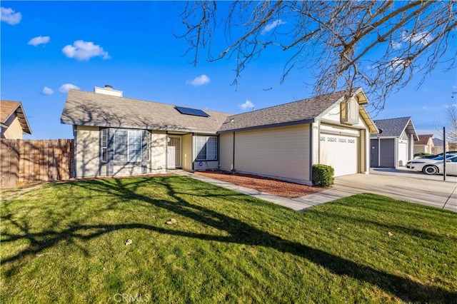 single story home with solar panels, a front yard, fence, a garage, and driveway