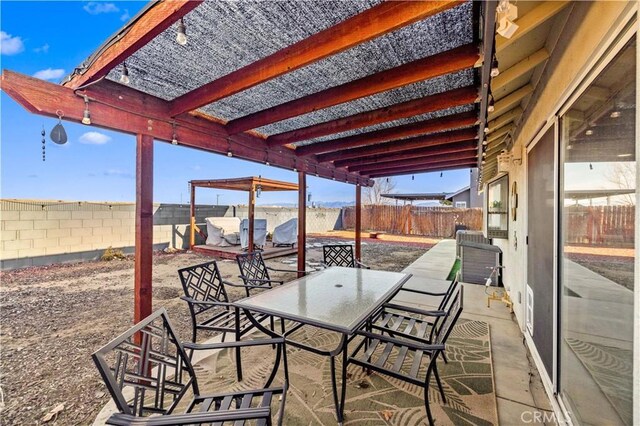 view of patio with outdoor dining area and a fenced backyard