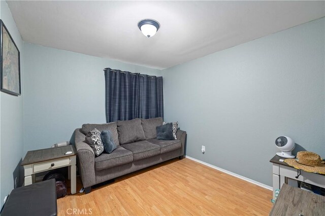 living area with wood finished floors and baseboards