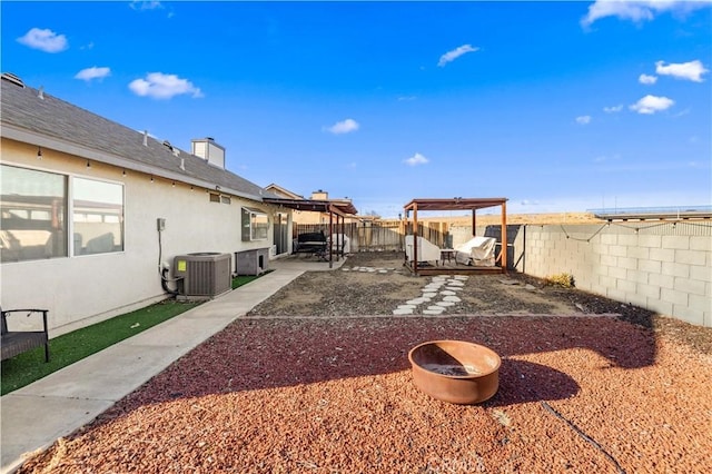 view of yard featuring a pergola, a fenced backyard, a patio, and central air condition unit