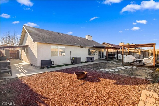 back of house with a patio, central air condition unit, fence, and stucco siding