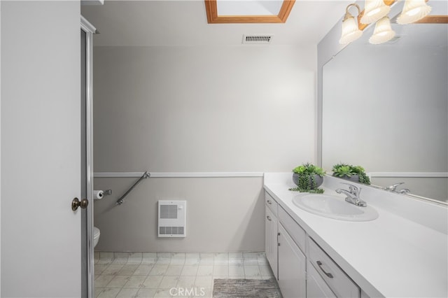1860 Mckinney Way Unit 21L, Seal Beach, CA 90740 - bathroom with visible vents, toilet, vanity, and heating unit
