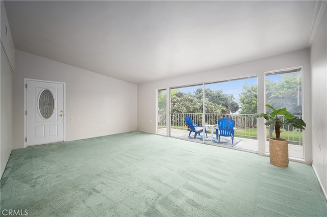 1860 Mckinney Way Unit 21L, Seal Beach, CA 90740 - unfurnished living room with a wealth of natural light, carpet, and vaulted ceiling