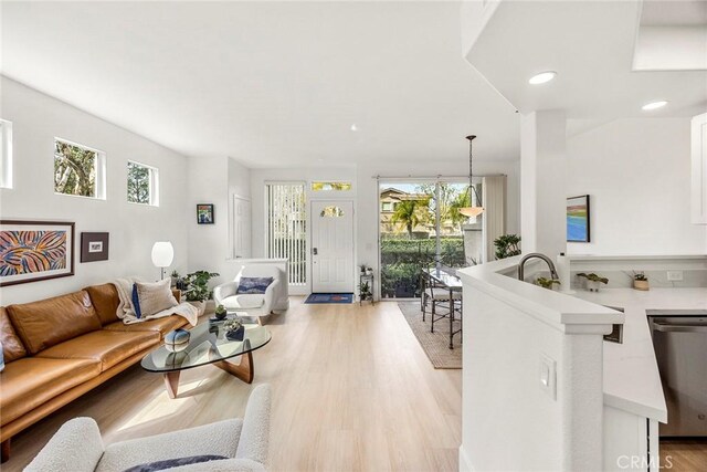 living room with light wood-style flooring and recessed lighting