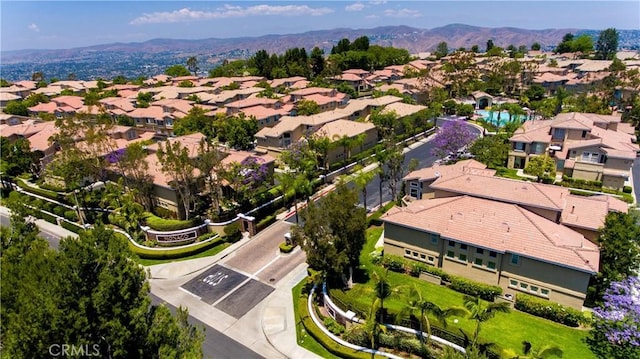 drone / aerial view featuring a residential view and a mountain view