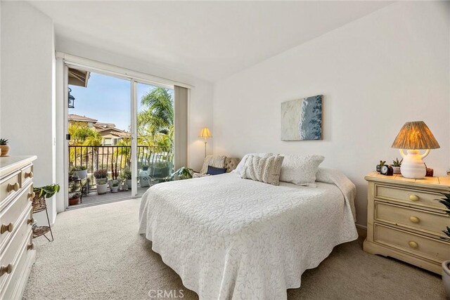 bedroom with access to outside and light colored carpet