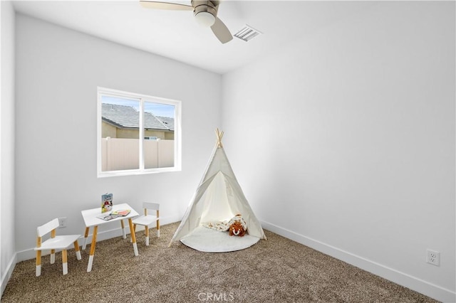 game room with carpet floors, visible vents, baseboards, and a ceiling fan