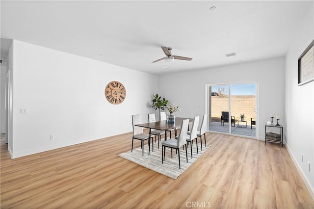 dining space with light wood-style floors, ceiling fan, and baseboards