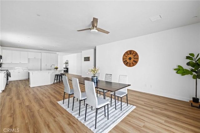 5651 W W Ave Unit J15, Lancaster, CA 93536 - dining room featuring a ceiling fan and light wood-style flooring