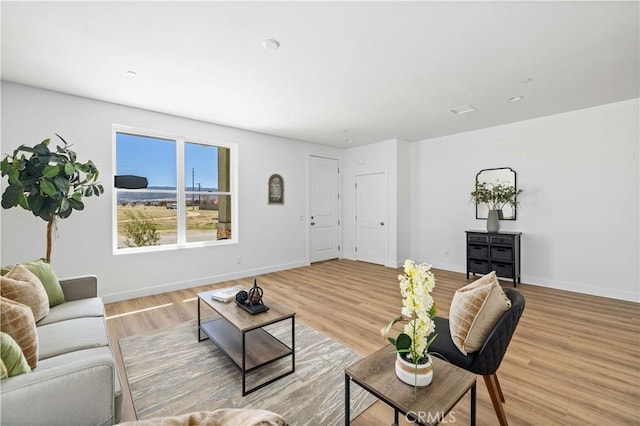 living room featuring light wood finished floors and baseboards