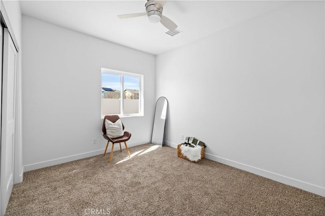 interior space featuring carpet floors, a ceiling fan, visible vents, and baseboards