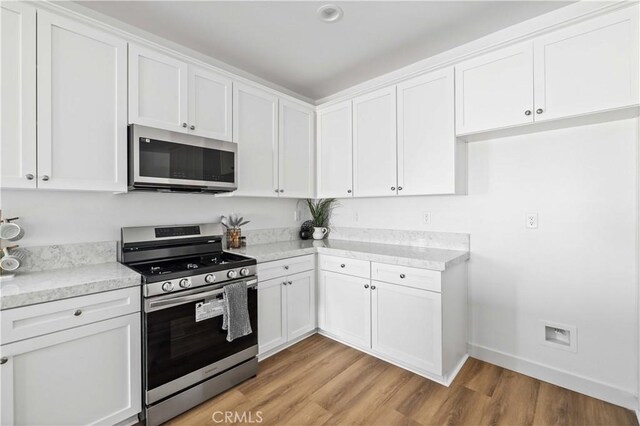 5651 W W Ave Unit J15, Lancaster, CA 93536 - kitchen featuring stainless steel appliances, light wood-style flooring, white cabinetry, and recessed lighting
