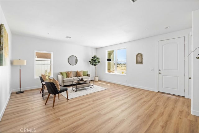 living room featuring light wood-type flooring and baseboards