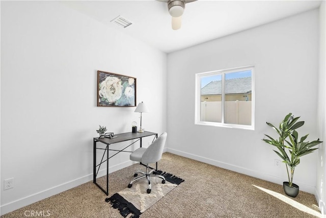 carpeted home office featuring a ceiling fan, visible vents, and baseboards