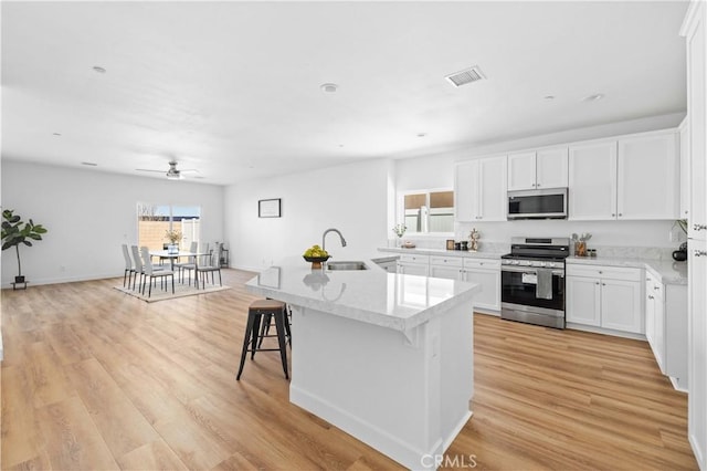 5651 W W Ave Unit J15, Lancaster, CA 93536 - kitchen with stainless steel appliances, plenty of natural light, light wood-style floors, and a ceiling fan